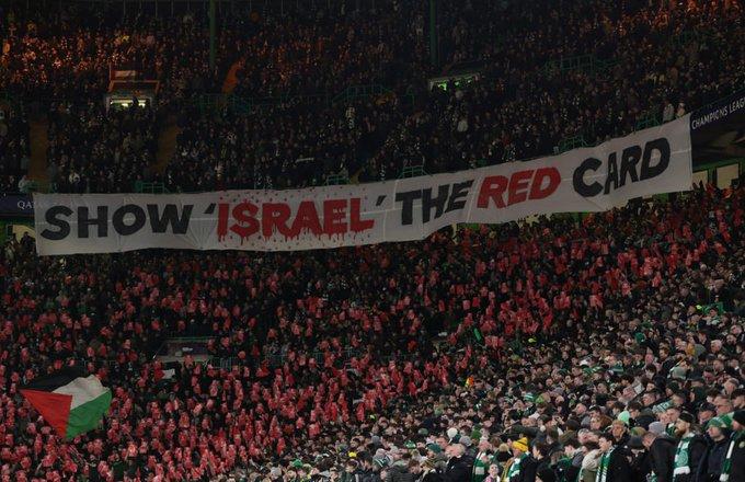 A huge banner reading SHOW ISRAEL THE RED CARD