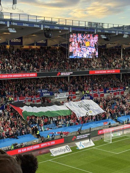Huge banners and Palestinian flags in the stands
